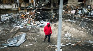 © UNICEF/Anton Skyba for The Globe and Mail A man walks in front of a crater left by an explosion during escalating conflict in Kyiv, Ukraine